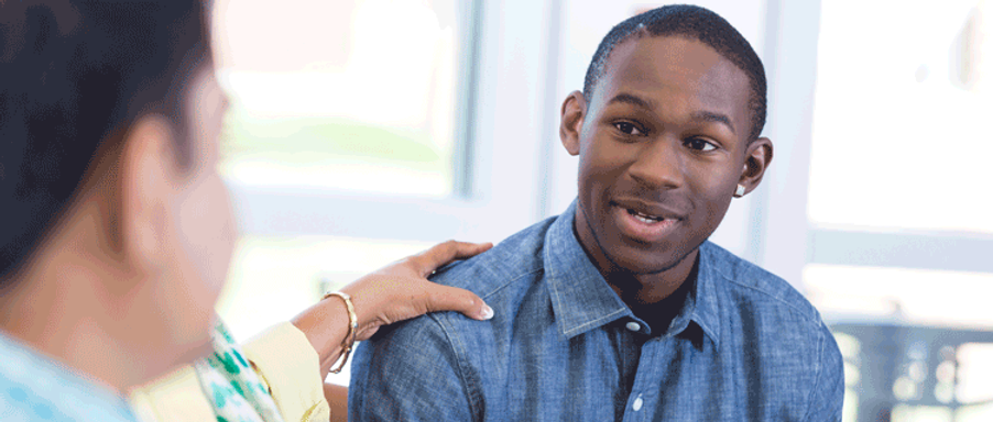 A man talking to another about education to employment pipeline program